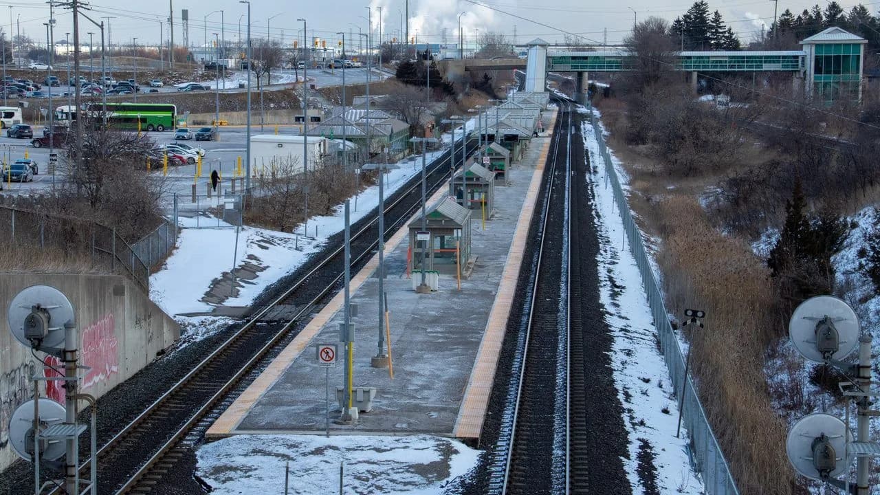 Whitby GO station platforms and parking lot seen from the Henry Street overpass; no identifiable people.
