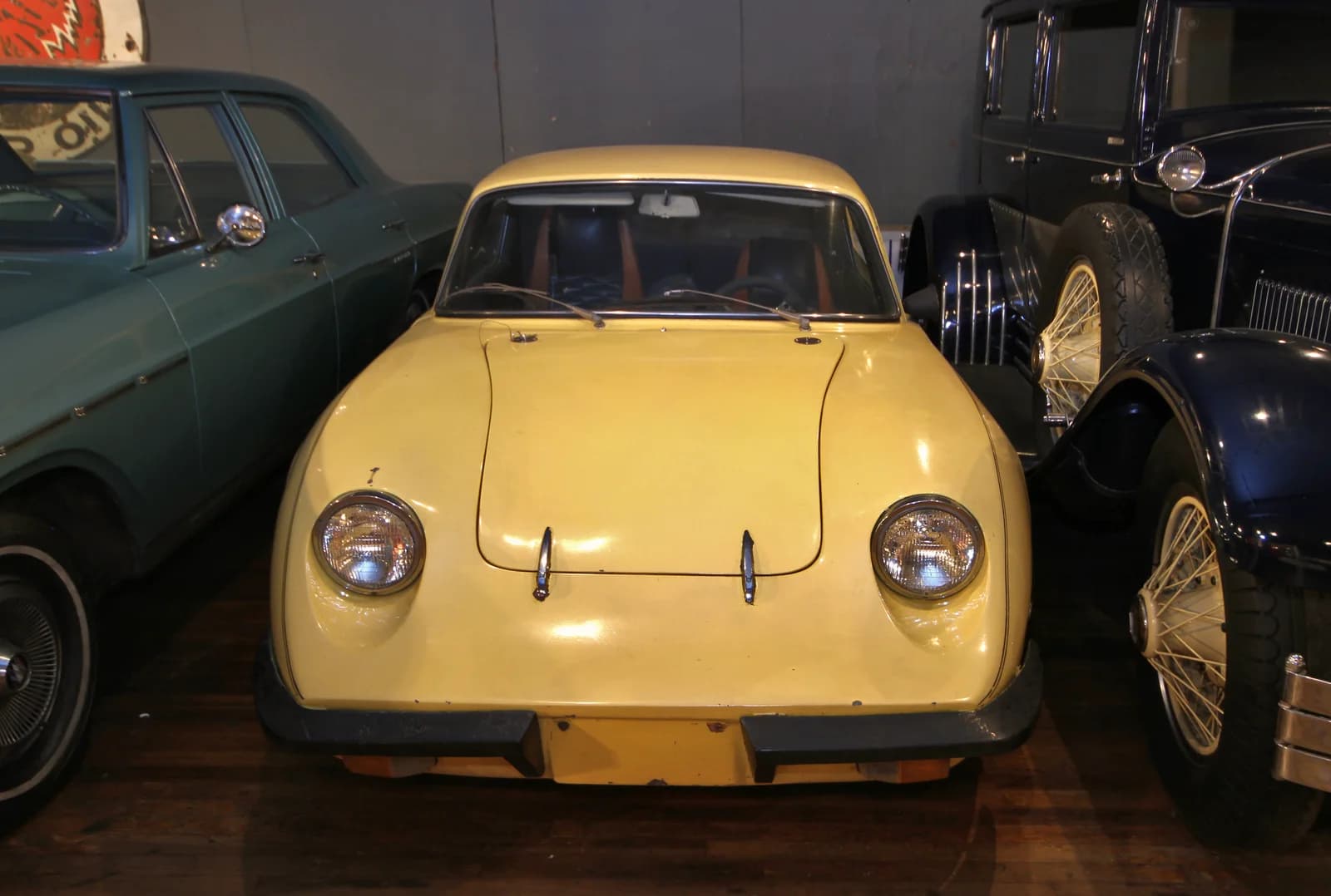 Yellow Manic GT among vintage cars inside the Canadian Automotive Museum in Oshawa.